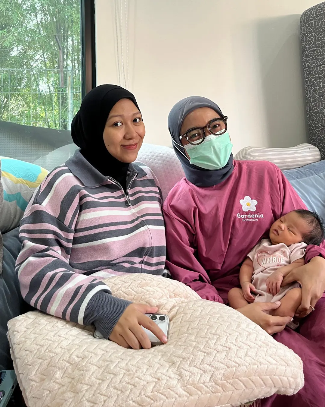 Gardenia midwife with a mother and her newborn during a home visit